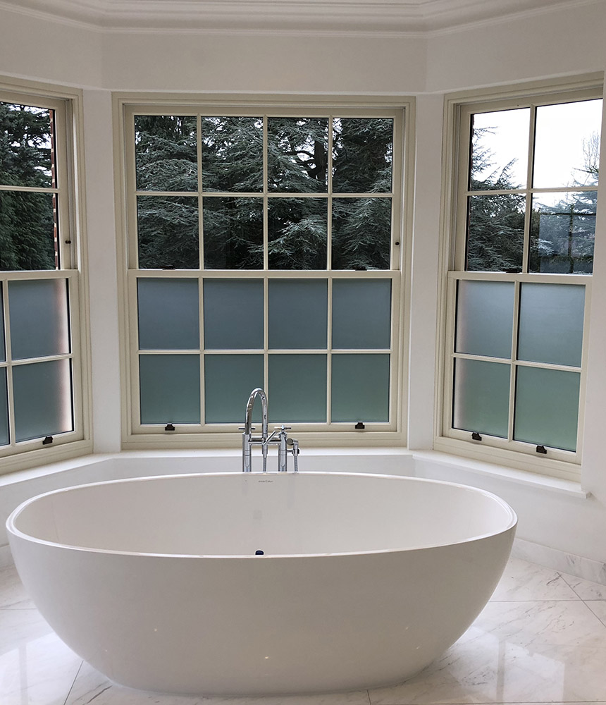 Privacy window film installation in bathroom setting